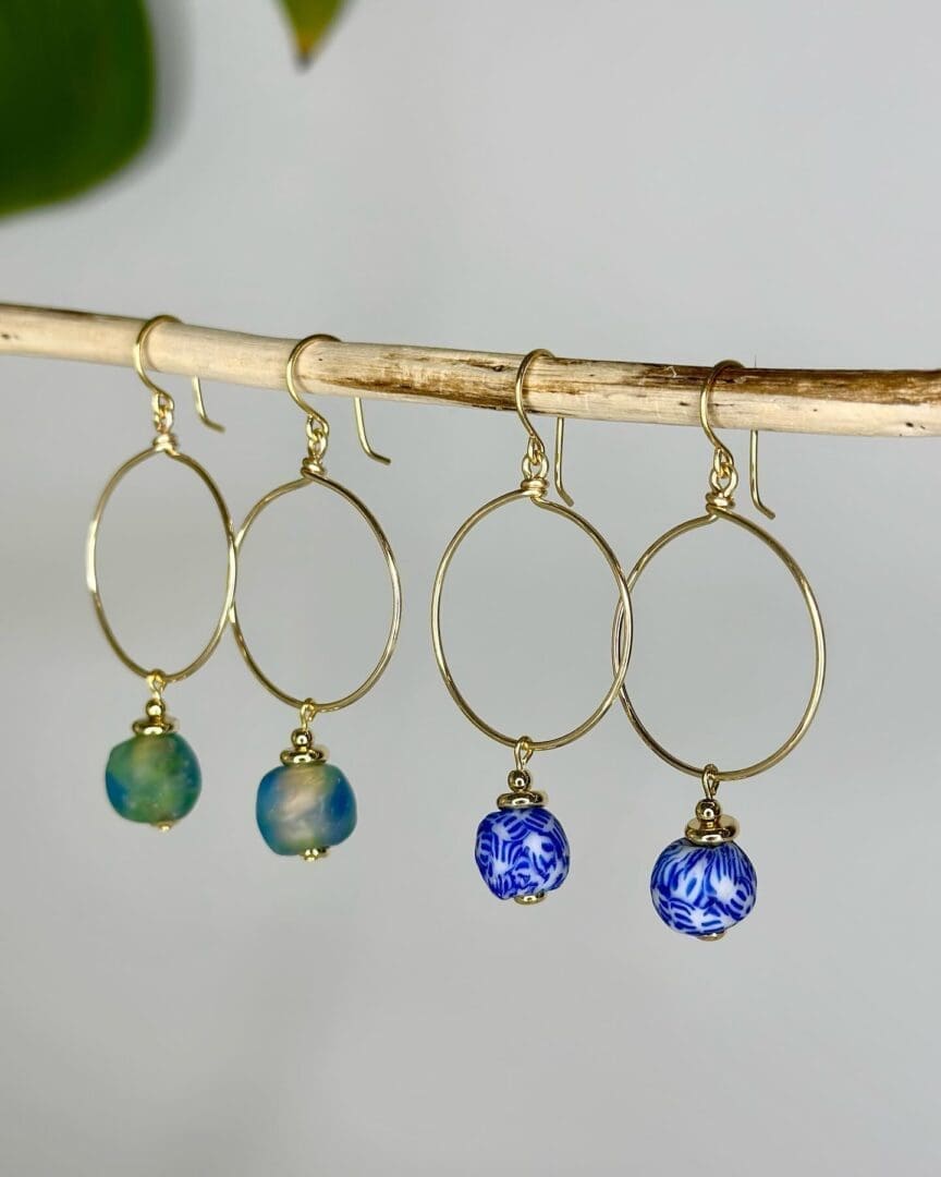 A pair of earrings hanging on a branch.