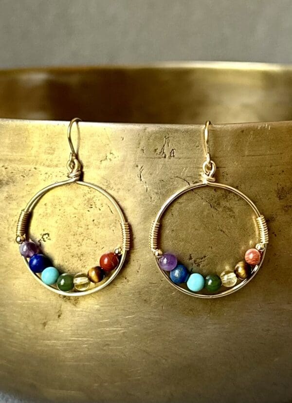 A pair of earrings with colorful beads on them.