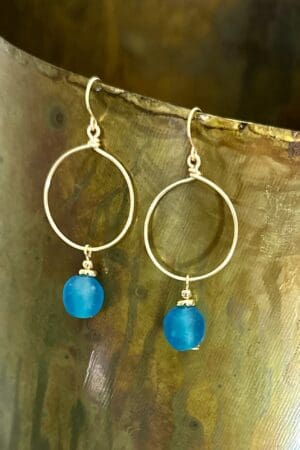 A pair of earrings hanging on top of a tree.