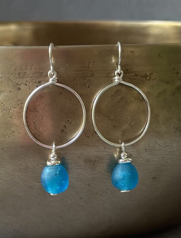 A pair of earrings hanging on the wall.