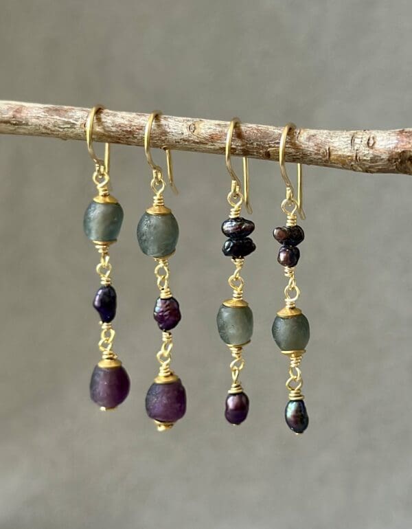 A pair of earrings hanging on a tree branch.